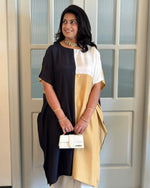 Woman wearing a two-tone kurta with a white door in the background