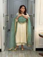 Woman in a traditional outfit standing in a doorway
